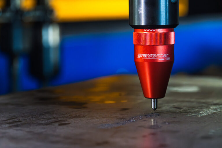 Gravostar marking tool mounted on a drilling tool station processing material on a cutting table