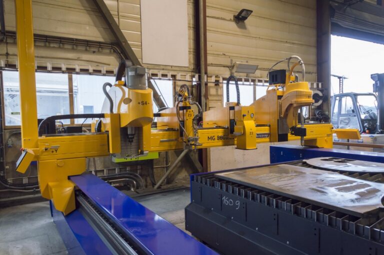 An MG machine's gantry with a drilling tool station, an oxyfuel cutting tool station, a marking tool station and a plasma rotator
